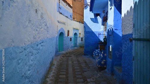 Walking through a narrow blue street in Chefchaouen, Morocco