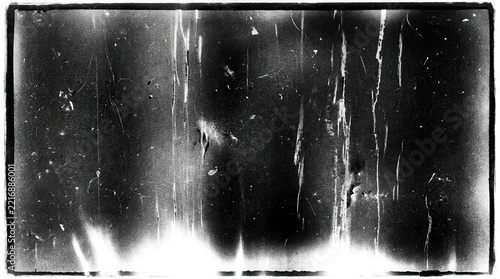 Distressed film overlay texture with scratches and light leaks on a black background