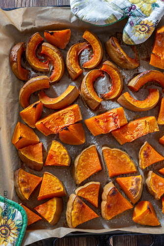 Roasted pumpkin slices on baking tray.