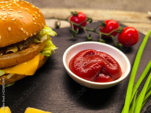 An appetizing, delicious homemade burger made from minced beef on a wooden table.
