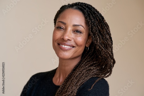 happy serene woman looking at camera with gentle authentic toothy smile