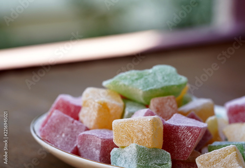 Macro Close-Up of Assorted Colorful Turkish Delight Cubes Served on a Ceramic Plate