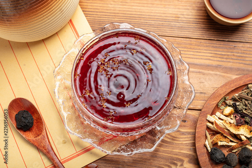 Traditional Sour Plum Herbal Drink with Dried Ingredients on Wooden Table