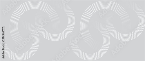 Abstract light grey background featuring elegant interlocking wave patterns created by fine white concentric curved lines.