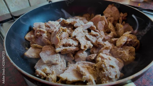Frozen Meat Cooking in Hot Frying Pan with Steam