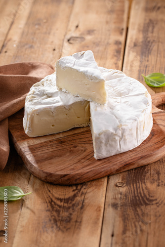 Fresh Brie cheese with herbs. Camembert cheese.