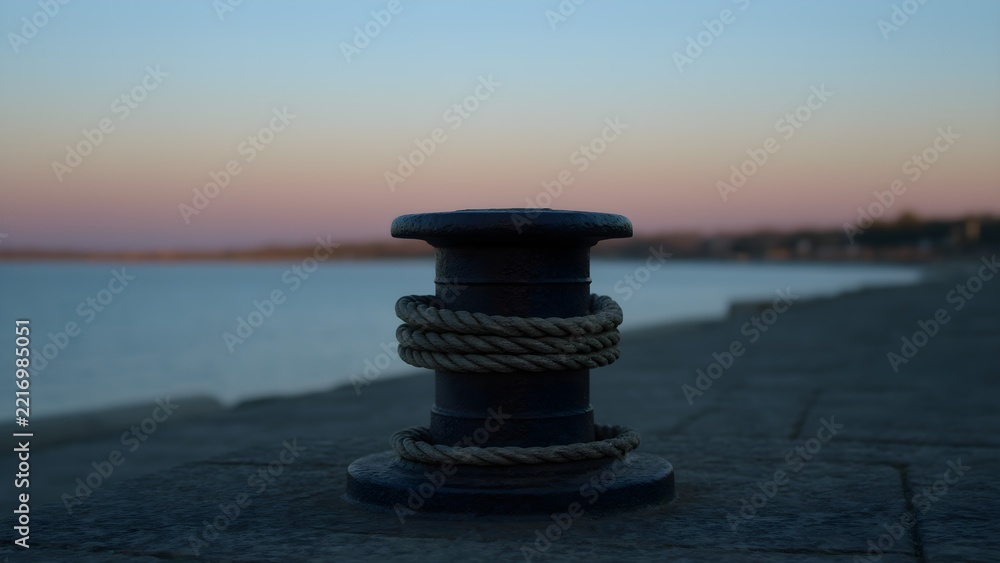 Fototapeta premium Iron mooring bollard with rope at a harbor at dusk, maritime detail