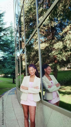 Confident young businesswoman smiling outside corporate building