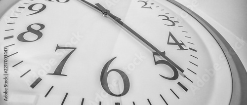 Modern wall clock with sleek hands and bold numbers in minimalist design