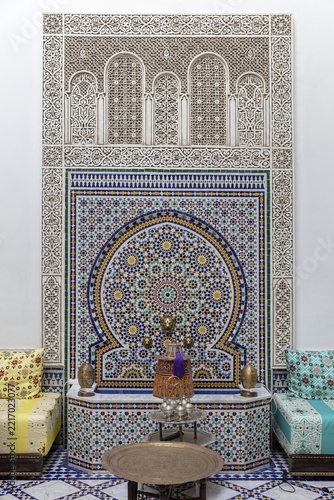 Richly decorated wall decoration with mosaics and traditional seating furniture