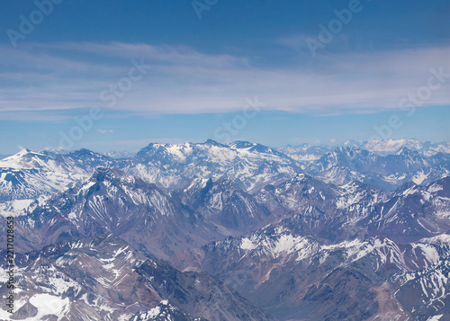 Chilean andes range mountains on a sunny day from window plane point of view