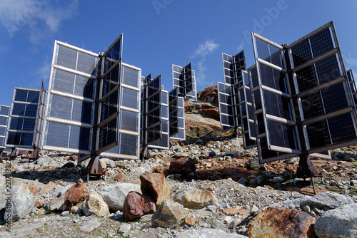Detail of solar panels in mountains vertically mounted as four wings around central column like tree, photovoltaic plant avoid snow accumulation, future innovation energy concept