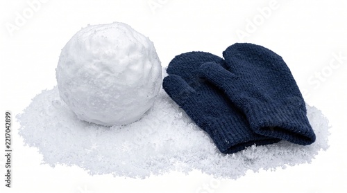 Snowball and blue mittens on fresh snow for winter children outdoor play activity. A pair of warm knitted gloves rests beside a round snowball on a white snowy background.