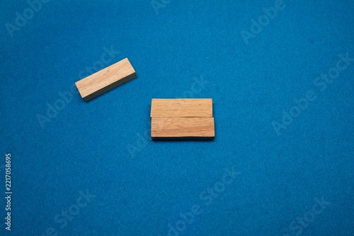 Wooden blocks and card holder on blue background