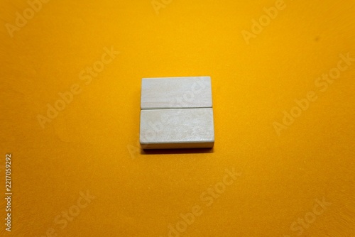 Wooden card holder on yellow background