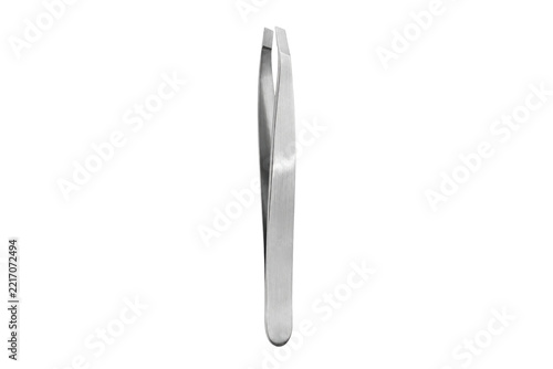 Obraz na plátně Single shiny silver metal cosmetic tweezer stands upright on a clean white backg