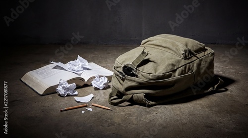 School Bullying Trauma, A torn school backpack and scattered books symbolize youth violence