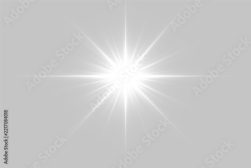 A bright white starburst radiates light with symmetrical sharp beams extending in all directions on a black background. The intense glow creates a striking contrast and dynamic visual.
