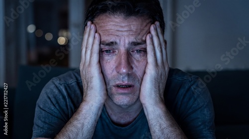 Overwhelming Despair, A middle-aged man sits in the dark, experiencing profound heartbreak