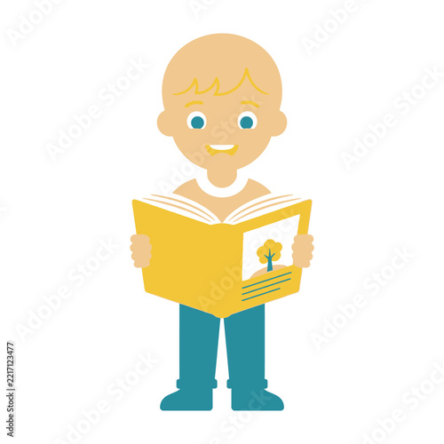 Smiling young boy reading a big yellow book with a tree on the cover outside