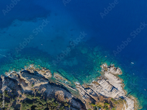 Aerial view of the rocky coastline and turquoise waters of Sant'Andrea on Elba island, featuring rugged cliffs and Mediterranean vegetation, Sant'Andrea, Tuscany, Elba island, Italy.