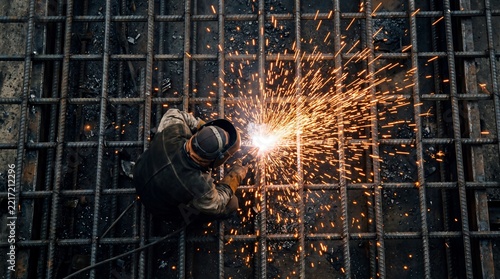 Overhead View of Welder Working with Steel Rebar