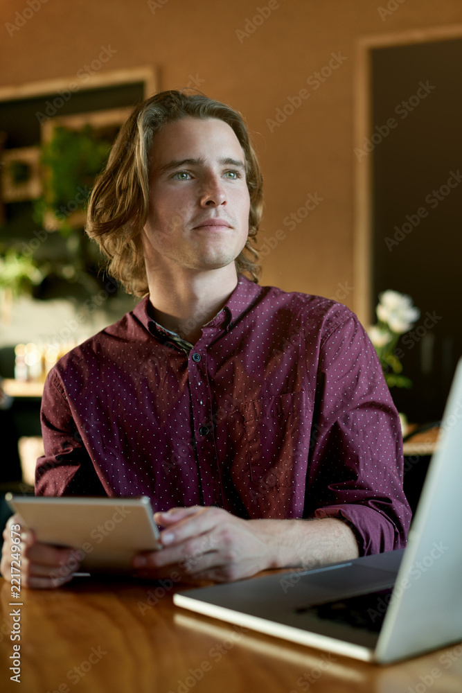 Obraz premium Thinking, remote work and man with tablet, cafe and creative for digital magazine, app and employee. Reflection, reporter and person with tech for article, online or freelance project in coffee shop