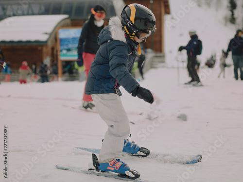 Young girl skiing together down a slope during a ski lesson in Chamrousse