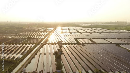 solar panels reflecting on water surface at sunset