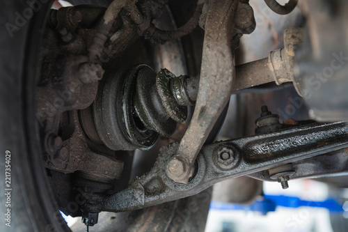 Close-up of worn out ,broken automotive CV axle rubber boots.
