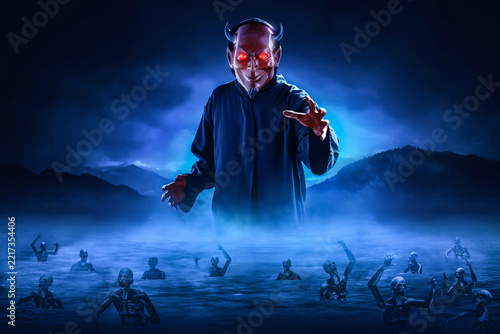 Red devil with horns tormenting souls in lake of fire, Halloween theme