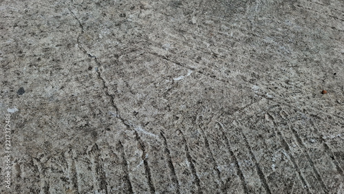 Obraz na plátně Macro shot of worn weathered grey concrete surface with fine line cracks
