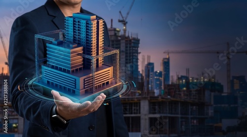 Professional architect holding digital holographic building with copy space layout
