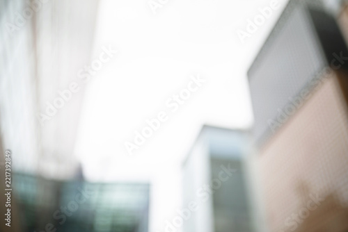 Abstract blurred background of modern city skyscrapers looking up at the sky