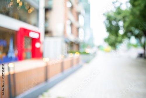 Abstract blurred background of modern city shopping street storefront and sidewalk
