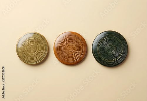 Sustainability and eco design, three circular wooden coasters with natural grain texture for interior decor and minimalist home styling on beige background