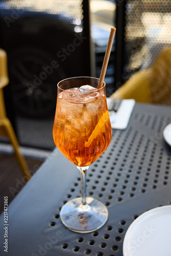 Refreshing Aperol Spritz Cocktail with Orange Slice and Ice on an Outdoor Terrace Table