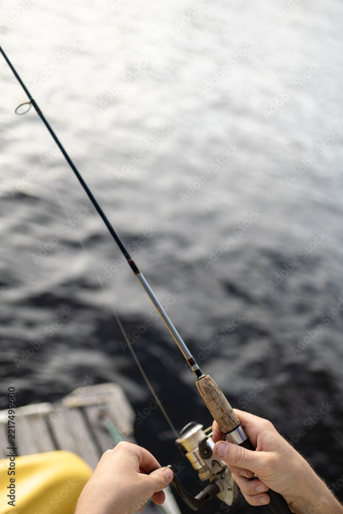 Fototapeta premium First person point of view of fishing from a wooden dock