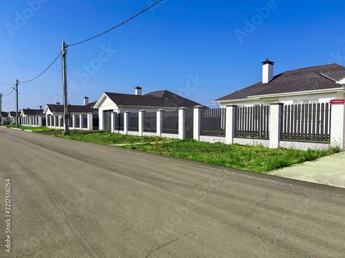A view from the street of the fences enclosing a private property.