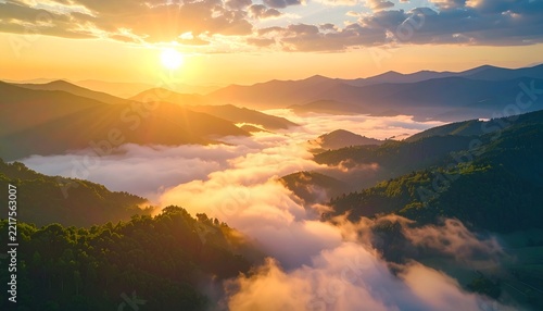 Sunrise over misty mountains, with golden rays illuminating the valley below. The serene landscape evokes a sense of peace and wonder
