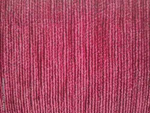 Fotografie Full frame background texture of dark red corduroy fabric with vertical lines