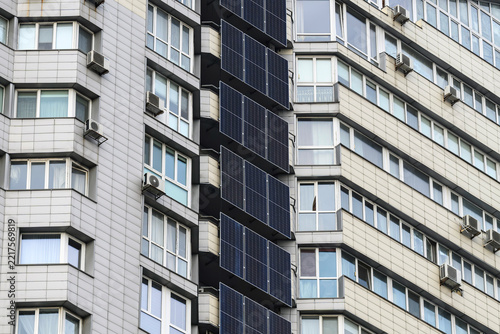 Solar panels and a battery storage system mounted on a modern apartment building in Kyiv, Ukraine, providing renewable energy and backup power for residential use.