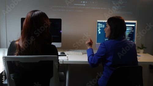 Female coders collaborating on software development project