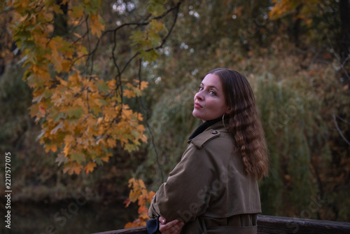 Photography Woman smiles beside Andreevsky Pond in Moscow beneath golden maple branches with willow behind