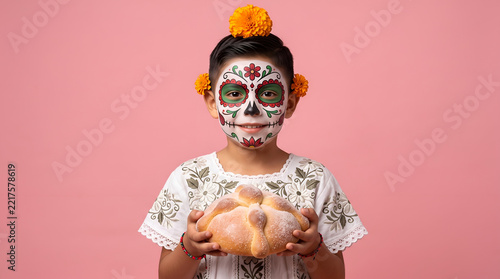 Mexican Boy with Sugar Skull Catrina Makeup Holding Traditional Pan de Muerto Bread