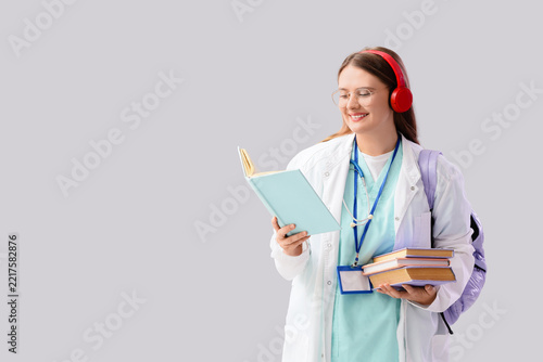 Medical education and student life, young doctor in training reading books wi...