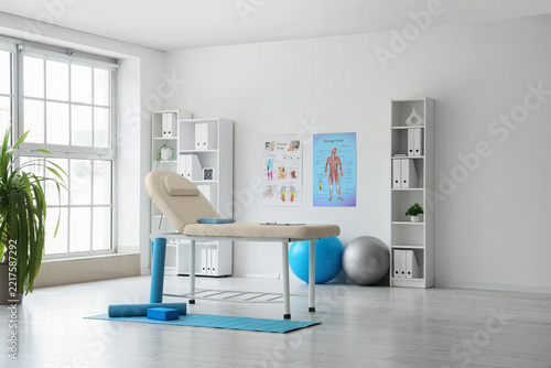 Physical therapy and rehabilitation clinic, massage table with exercise equip...