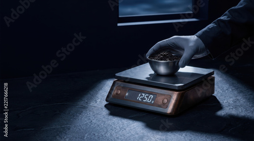 Food security solutions measured ingredient digital kitchen scale dark laboratory setting, highlighting precise handling, safety and quality