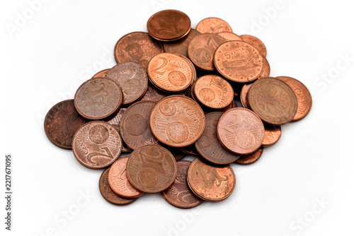 One, Two and Five euro cent coins on white. Selective focus.
