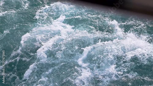 Close up view of the wake, back waves of a sailing boat.